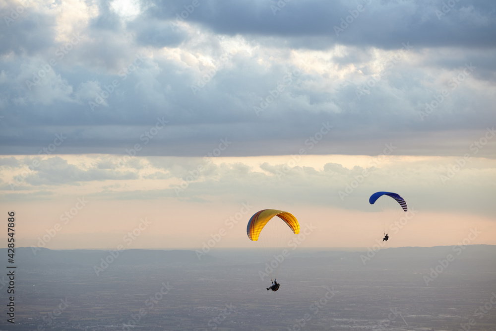 Paragliding in the sky at sunset