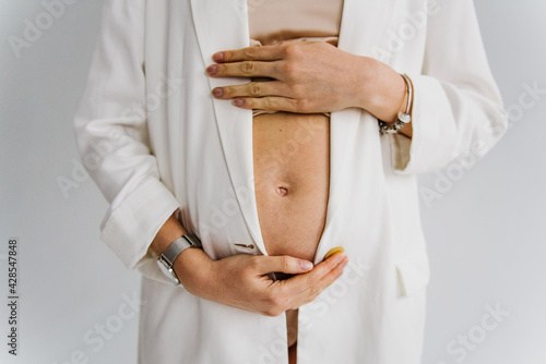 Pregnant tummy close up. © Oksana