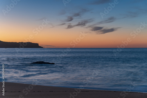 Sunrise seascape with scattered high cloud
