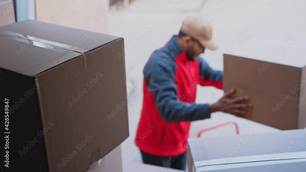 Young man unloading cardboard boxes from the truck. High quality 4k footage Young man unloading cardboard boxes from the truck. High quality 4k footage