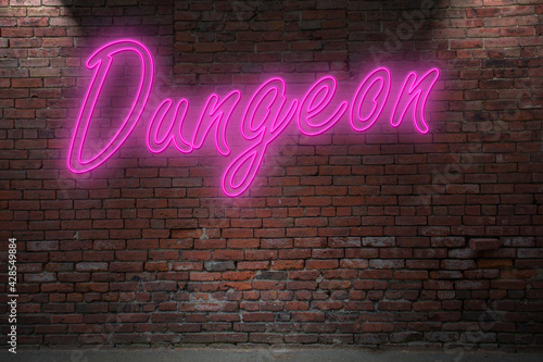 Neon Bondage Dungeon lettering on Brick Wall at night