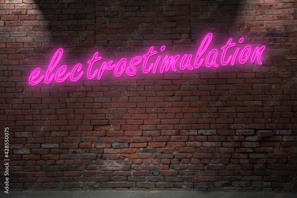Neon electrostimulation (in german Elektrostimulation) fetish lettering on Brick Wall at night