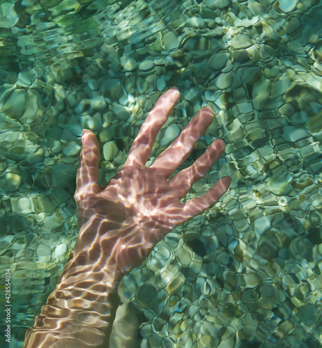 Human hand under the water, Adriatic sea in Pula, Croatia