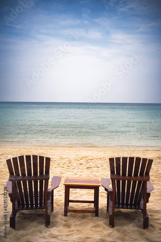 Beach chair under coconut tree looking away to sea view. Praw Bay  Samed Thailand.