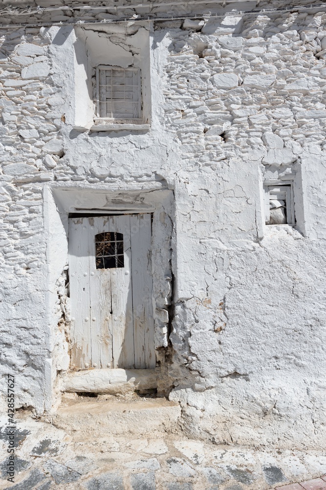 door and windows of old whitewashed farmyard in white color