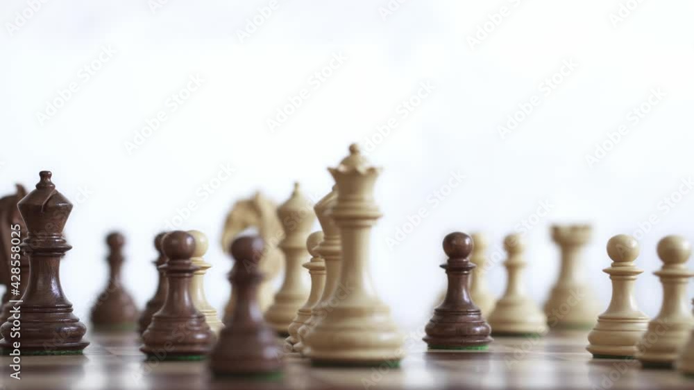 The chess pieces are located in a live game where the real multi-move tactics that are applied on this board play an important role. Chess pieces in beige and dark brown colors on a board The chess pieces are located in a live game where the real multi-move tactics that are applied on this board play an important role. Chess pieces in beige and dark brown colors on a board