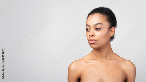 Portrait Of Black Woman Looking Aside Posing Shirtless, Gray Background
