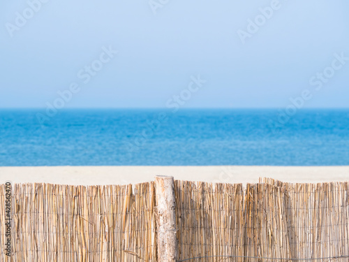 Summer landscape with a straw fence on the Modern beach in Constanta Romania