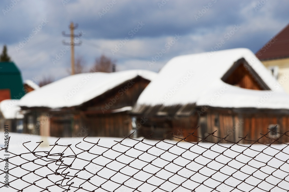 Fototapeta premium Cottage houses at winter countryside. Russian village houses