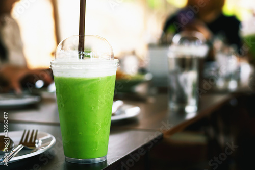 Green tea smoothie on a wooden table