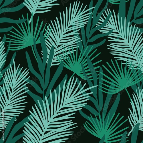 Seamless pattern with the image of tropical leaves on a dark background. Design for paper, textile and decor.