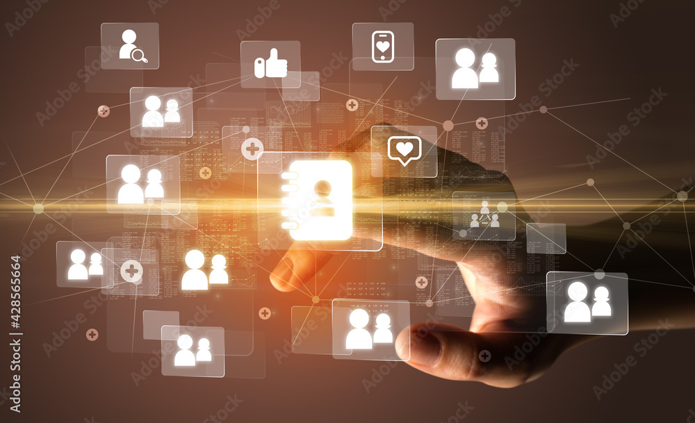 Hand pressing social media multimedia application screen with media icons on futuristic concept Hand pressing social media multimedia application screen with media icons on futuristic concept