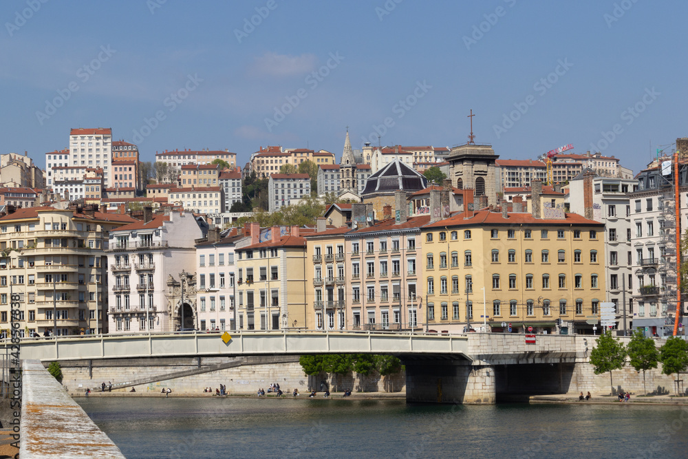 Facades of old buildings of Lyon France a bridge over the river Saône