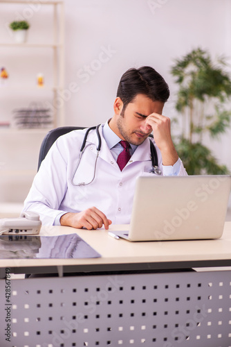 Young male doctor working in the clinic