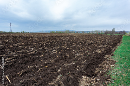 Agriculture plowed field. Black soil plowed. Landscape of farmland