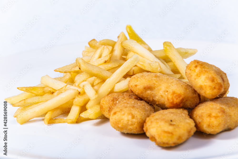 Fried cheese nuggets with french fries. The food in the restaurant. Food styling and restaurant meal serving.