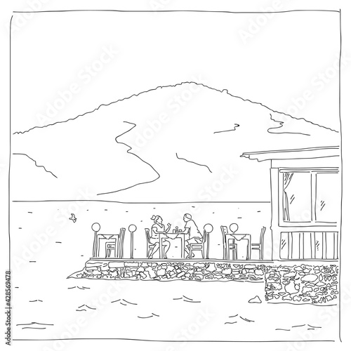 Two people are sitting in a restaurant on the beach