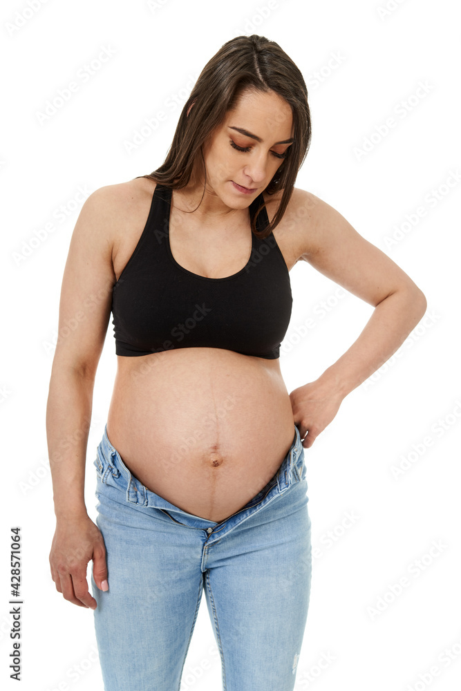 Pregnant woman trying to fit in tight jeans Pregnant woman trying to fit in tight jeans