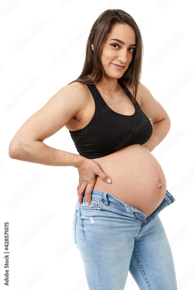 Pregnant woman trying to fit in tight jeans Pregnant woman trying to fit in tight jeans