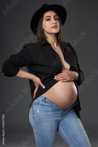 Pregnant woman in black shirt and blue jeans