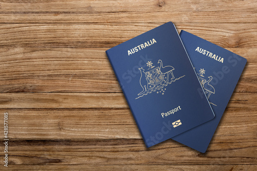 Top view, two Australian passports on a wooden board, the European Union
