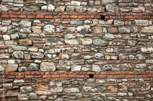 Old wall built of brick and stone  historic background