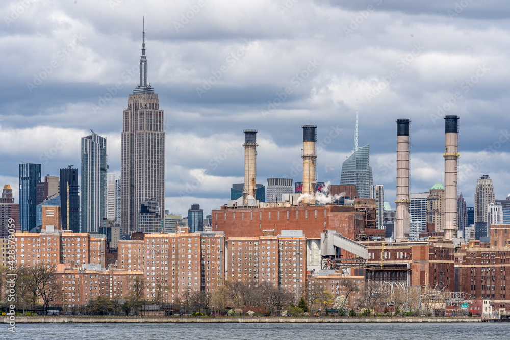 Brooklyn, NY - USA - April 17, 2021: View of the Empire State Building and Midtown Manhattan seen from Williamsburg across the East River.