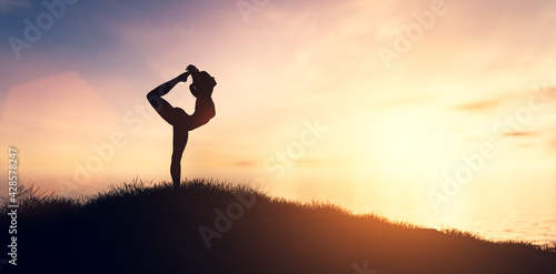 Woman in yoga pose, zen meditation at sunset.