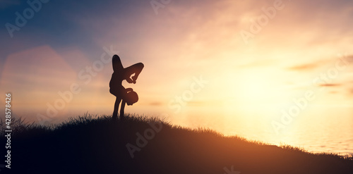 Woman in yoga pose  zen meditation at sunset.