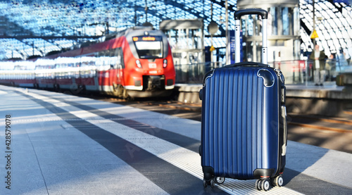 Ttravel suitcase on the railroad platform photo