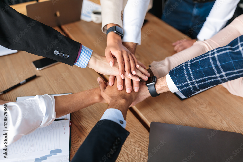 Fototapeta premium Top-View Of United Business Team Holding Hands In Office