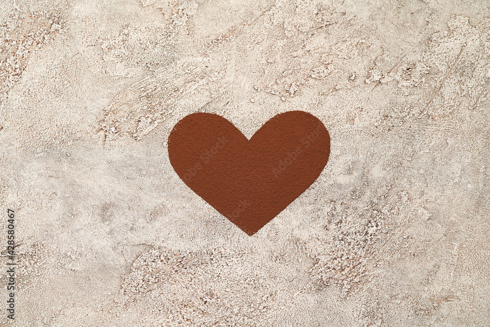 Heart shape made of coffee or cocoa powder on concrete background Heart shape made of coffee or cocoa powder on concrete background