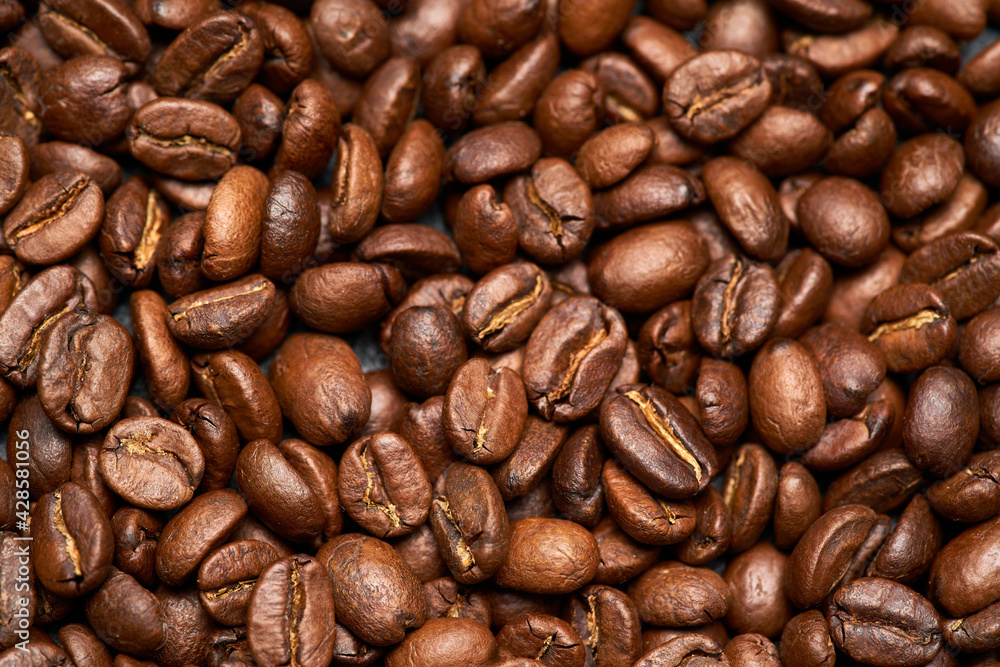Background or texture made of roasted brown coffee beans Background or texture made of roasted brown coffee beans