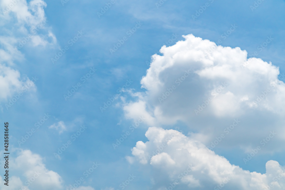 Blue sky with beautiful natural white clouds. Space for text. Background.