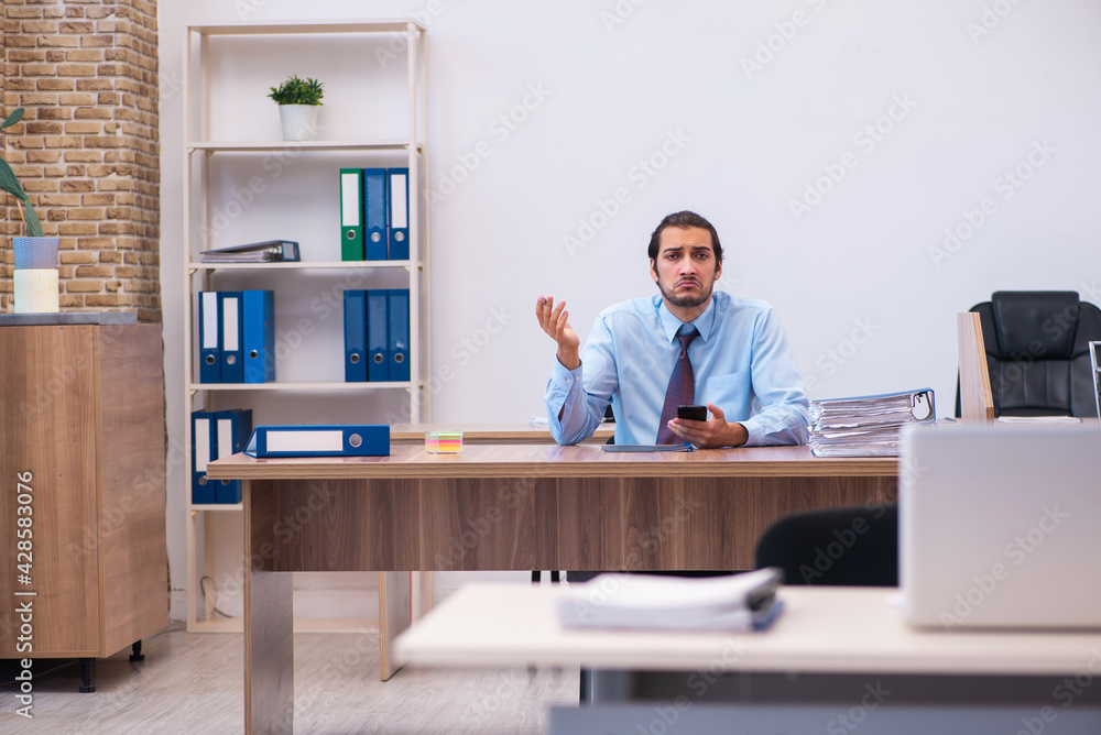 Young male employee working in the office