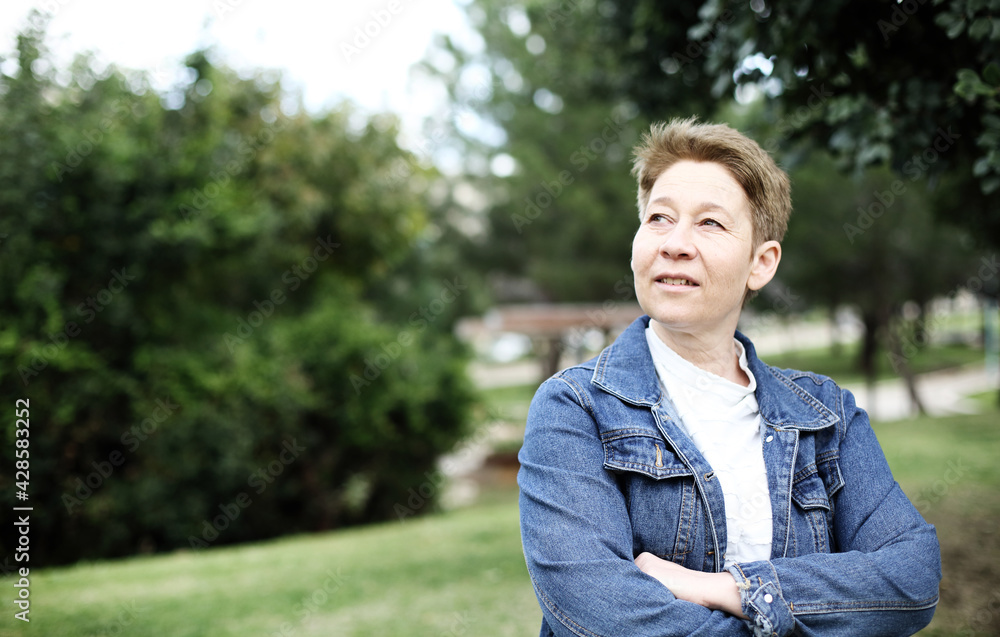 Portrait of mature woman in a city park Portrait of mature woman in a city park