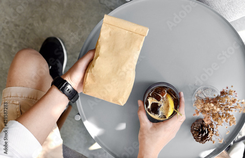 Barista man holding blank coffee package, Package design template mockup