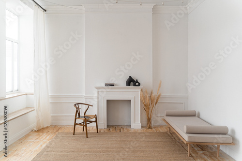 a bright space with white walls, high ceilings and wooden floors.