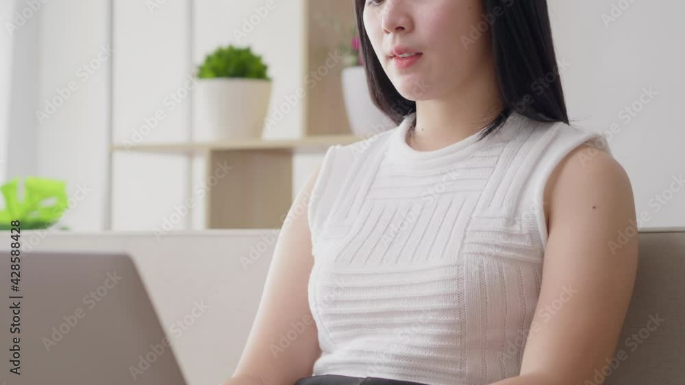 Asian businesswoman serious focus typing on laptop keyboard for work from home during quarantine coronavirus spread. Female in casual uniform online working in house for keep social distancing Asian businesswoman serious focus typing on laptop keyboard for work from home during quarantine coronavirus spread. Female in casual uniform online working in house for keep social distancing