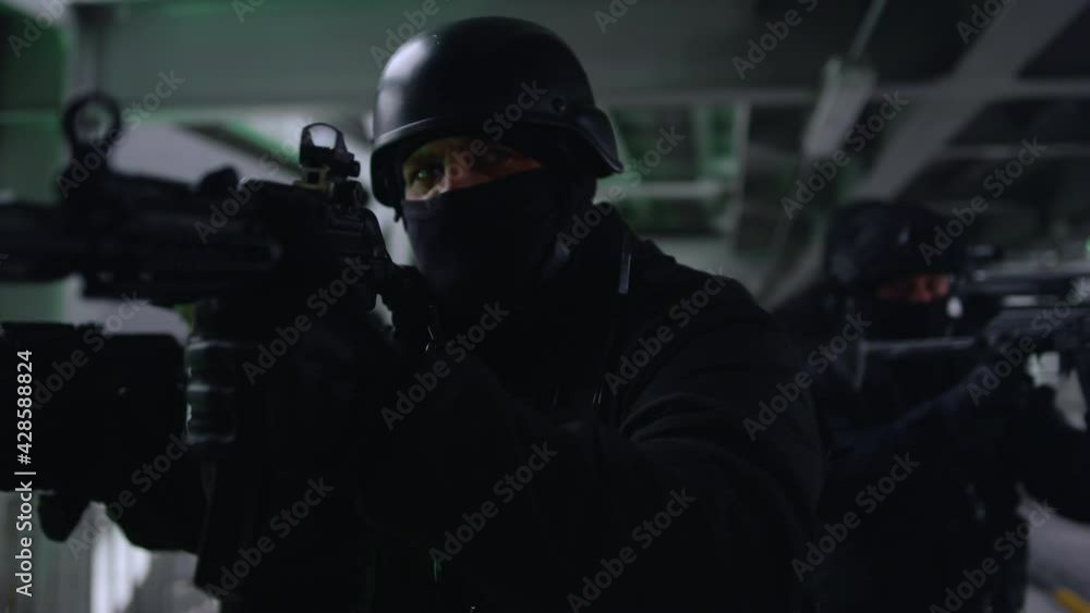 Anti terrorist squad looking through scopes on automatic rifles. SWAT police Anti terrorist squad looking through scopes on automatic rifles. SWAT police