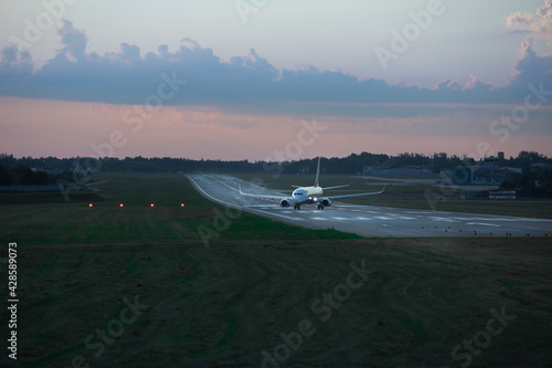 Lviv, Ukraine - August 10, 2020: plane on runway on sunset