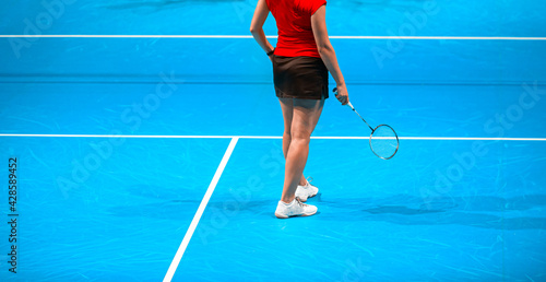 Badminton player beats the shuttlecock in the arena © Augustas Cetkauskas