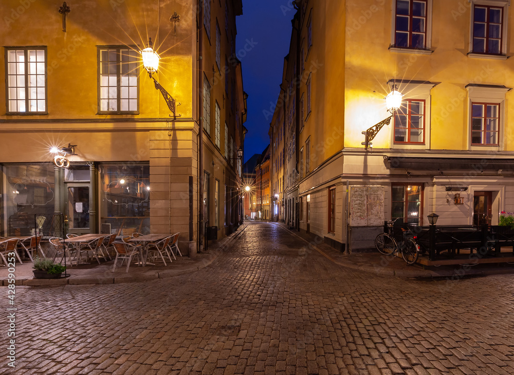 Fototapeta premium Stockholm. Old narrow medieval street in night lighting.