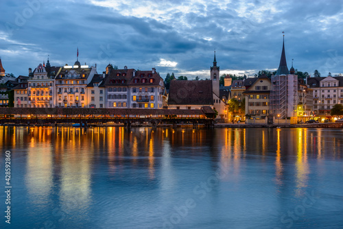 Night view towards Chapel Bridge (Kapellbruecke) together with the octagonal tall tower (Wasserturm) it is one of the Lucerne's most famous tourists attraction © karamysh
