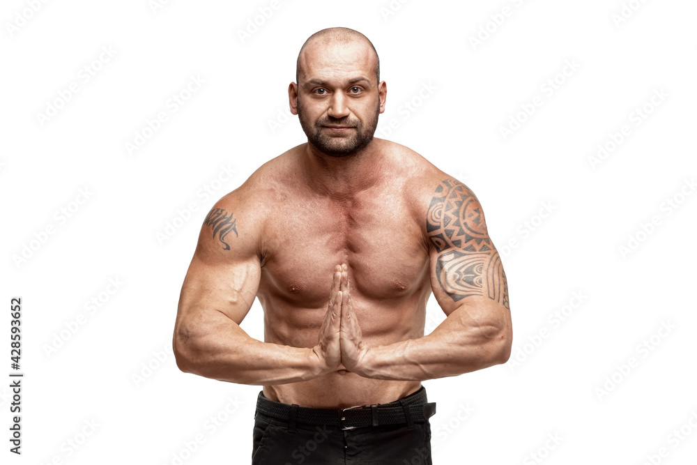 Tattooed male bodybuilder posing over white background. Fitness workout concept, muscle groups, watch your body. Tattooed male bodybuilder posing over white background. Fitness workout concept, muscle groups, watch your body.