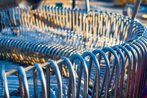 Close-up street bench metal pipes arranged parallel to each other on a street structure. Concept for weather resistant materials and modern industrial design. Advertising space