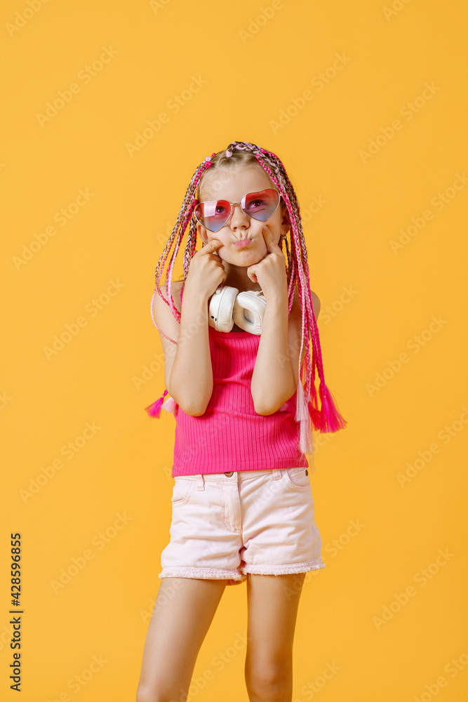 Crazy expressive trendy DJ girl in bright clothes, headphones an Crazy expressive trendy DJ girl in bright clothes, headphones an