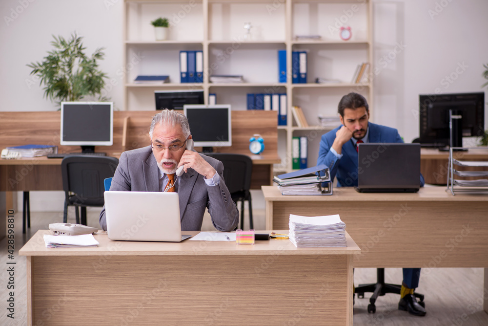 Two male employees working in the office Two male employees working in the office