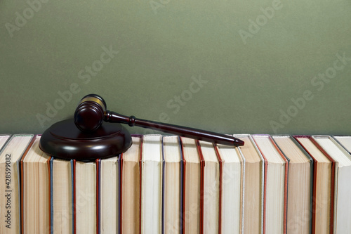  law book with a wooden judges gavel on table