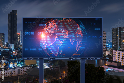 Hologram of Earth planet map on billboard over night panoramic cityscape of Bangkok. The concept of international companies in Southeast Asia.